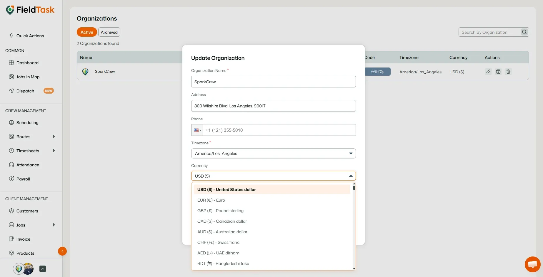 Currency dropdown open in the organization settings modal
