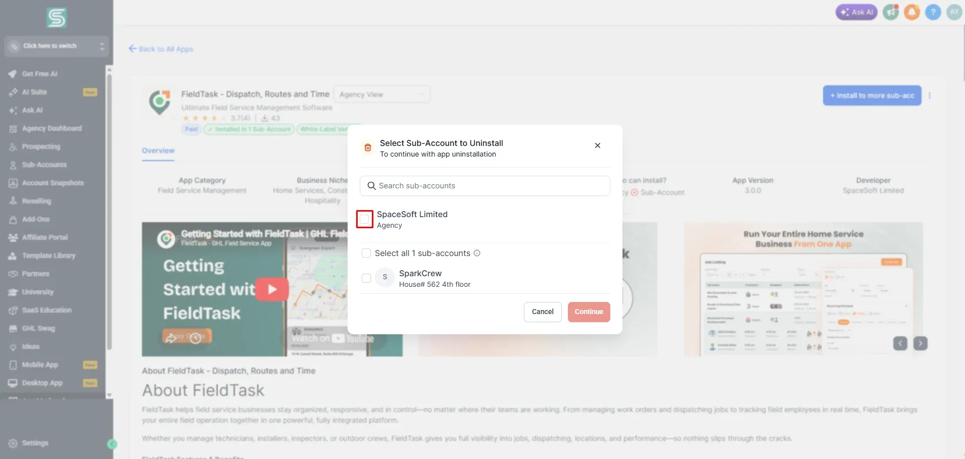 FieldTask app overview in GoHighLevel with a Select Sub-Account to Uninstall modal open over a blurred page. It lists SpaceSoft Limited and SparkCrew with checkboxes, and a red box highlights the SpaceSoft Limited checkbox before continuing.